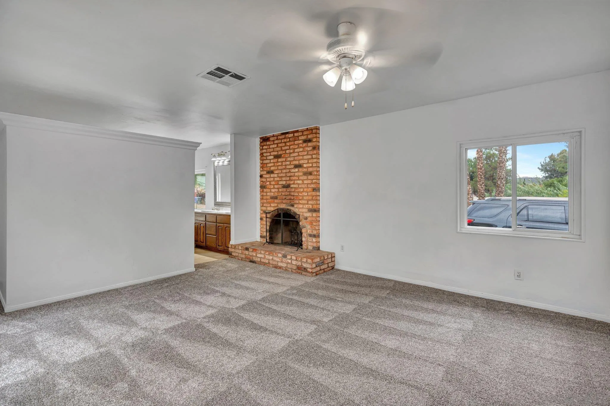 14414 Poway Road Poway, CA 92064 - Photo 15 of 27 an empty room with windows chandelier fan and fireplace