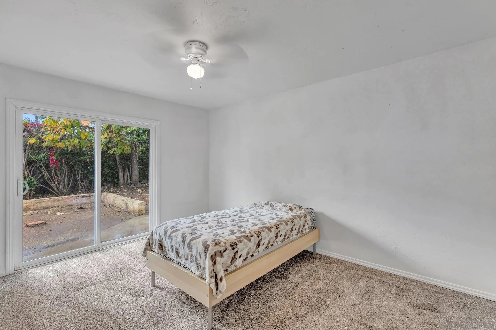 14414 Poway Road Poway, CA 92064 - Photo 22 of 27 a bedroom with a bed and glass door