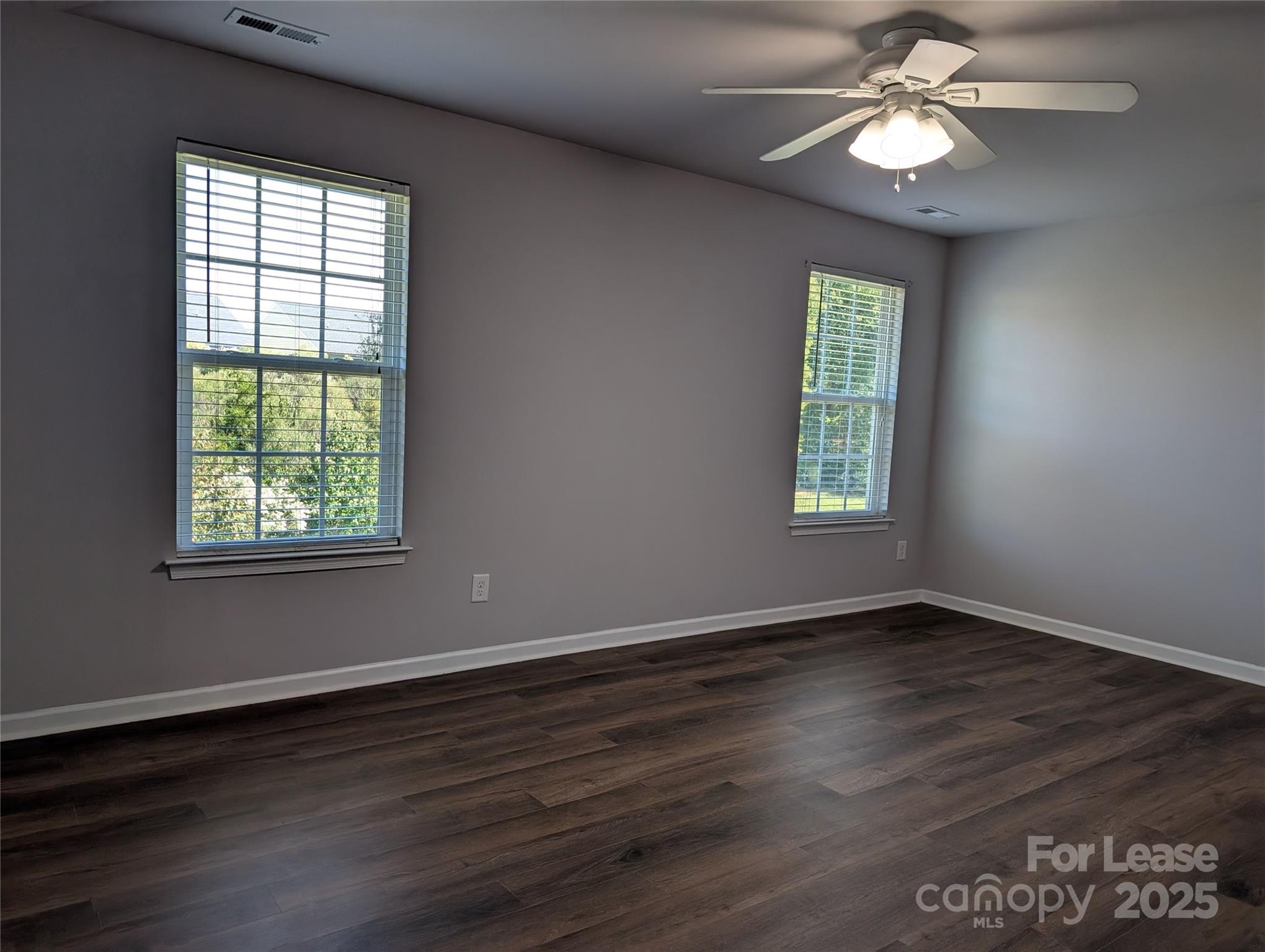 4432 Roundwood Court Indian Trail, NC 28079 - Photo 11 of 25 a view of an empty room with wooden floor and a window