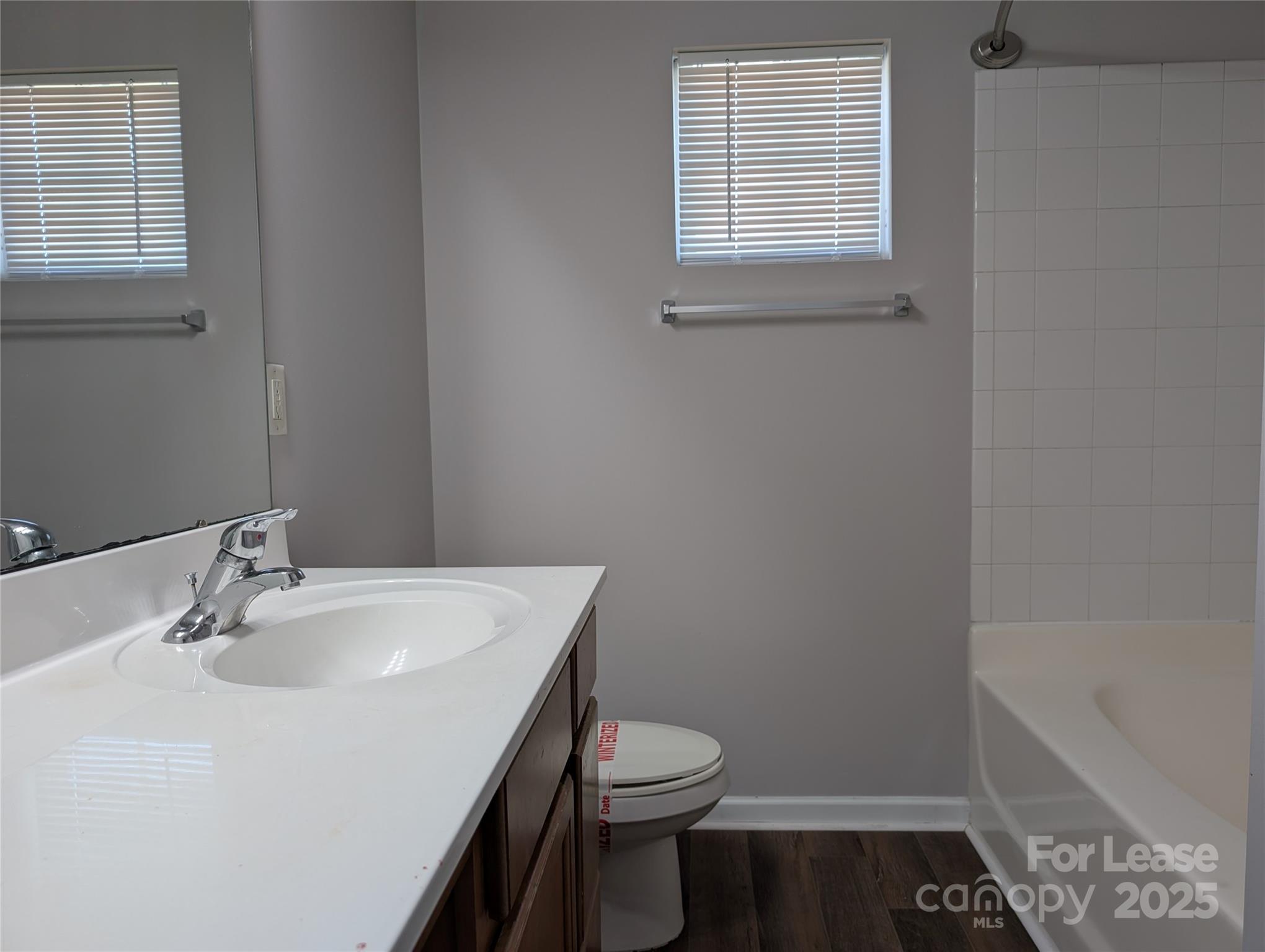 4432 Roundwood Court Indian Trail, NC 28079 - Photo 13 of 25 a bathroom with a sink a toilet and shower