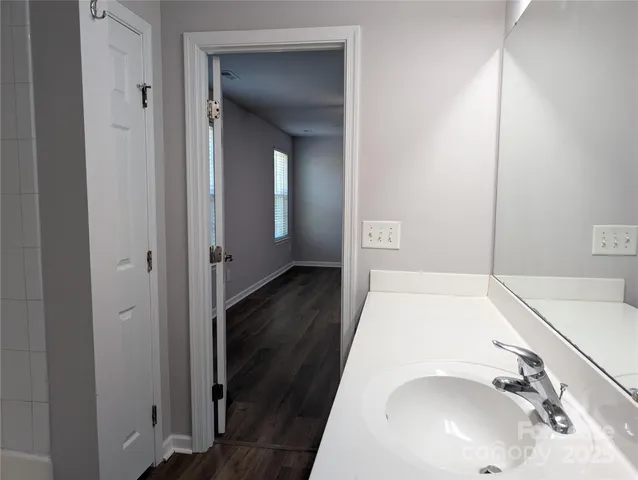 a en suite bathroom with a sink and a mirror