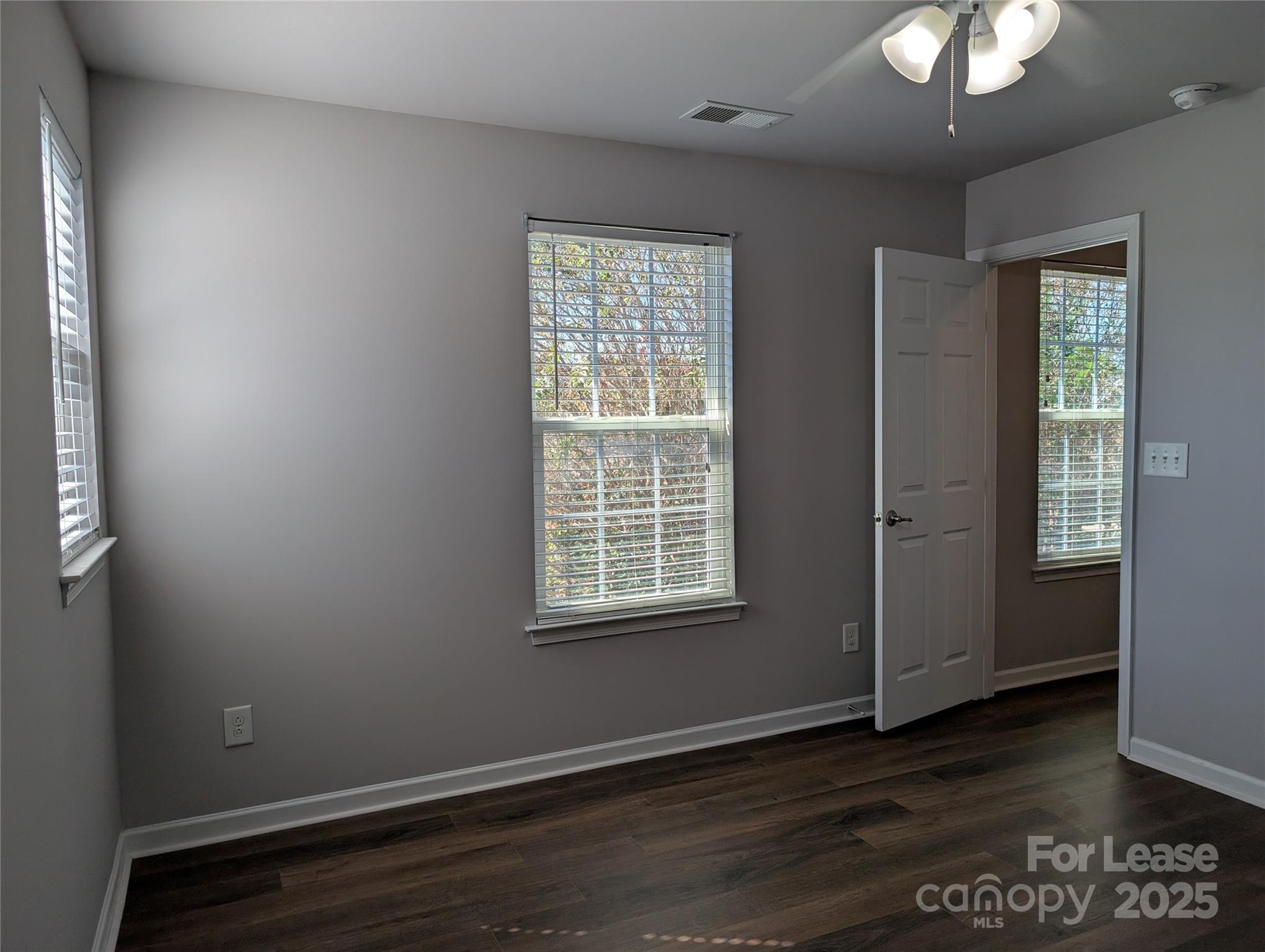 4432 Roundwood Court Indian Trail, NC 28079 - Photo 15 of 25 a view of an empty room with wooden floor and a window