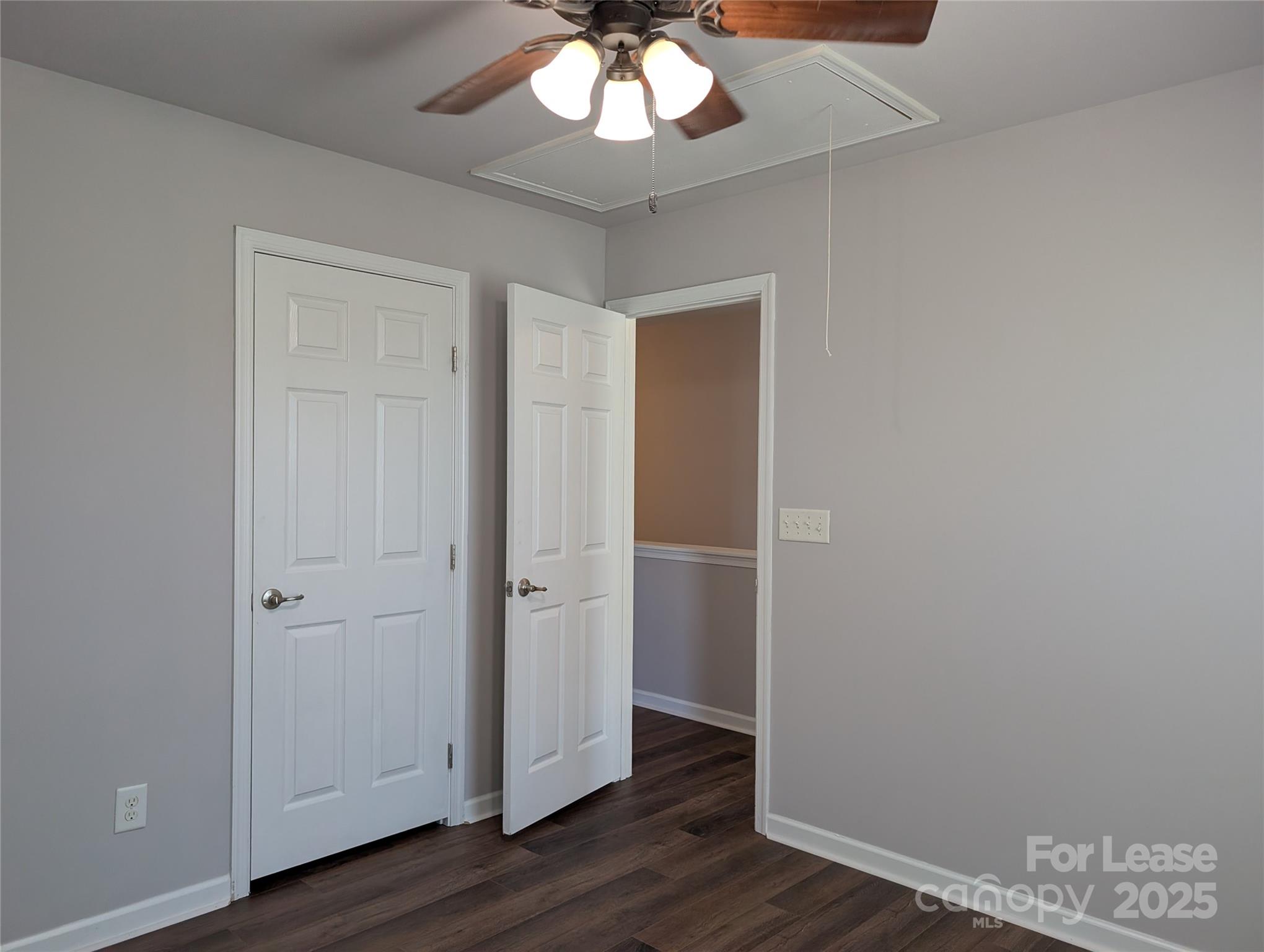 4432 Roundwood Court Indian Trail, NC 28079 - Photo 17 of 25 an empty room with wooden floor and ceiling fan