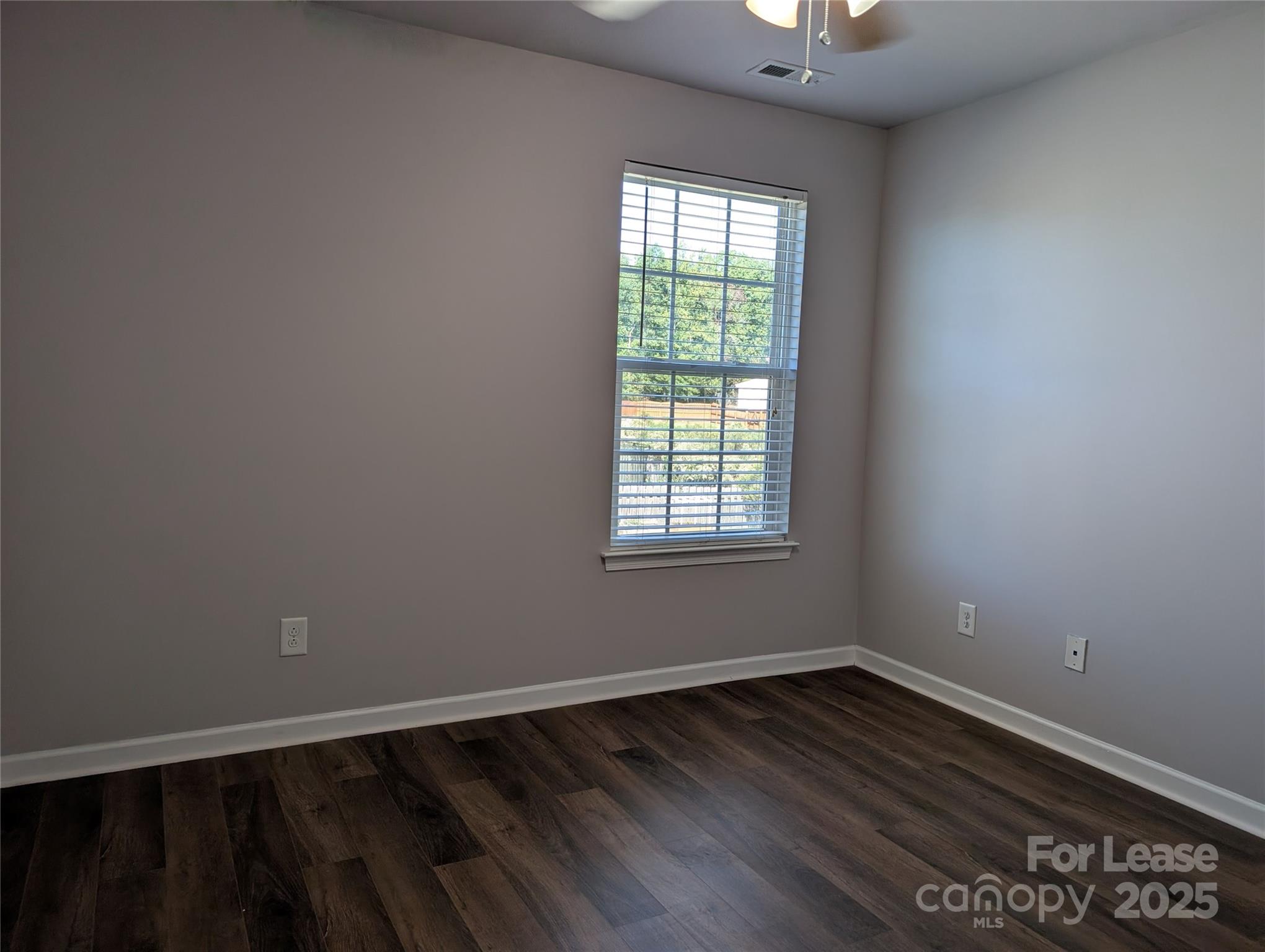 4432 Roundwood Court Indian Trail, NC 28079 - Photo 20 of 25 an empty room with wooden floor and windows