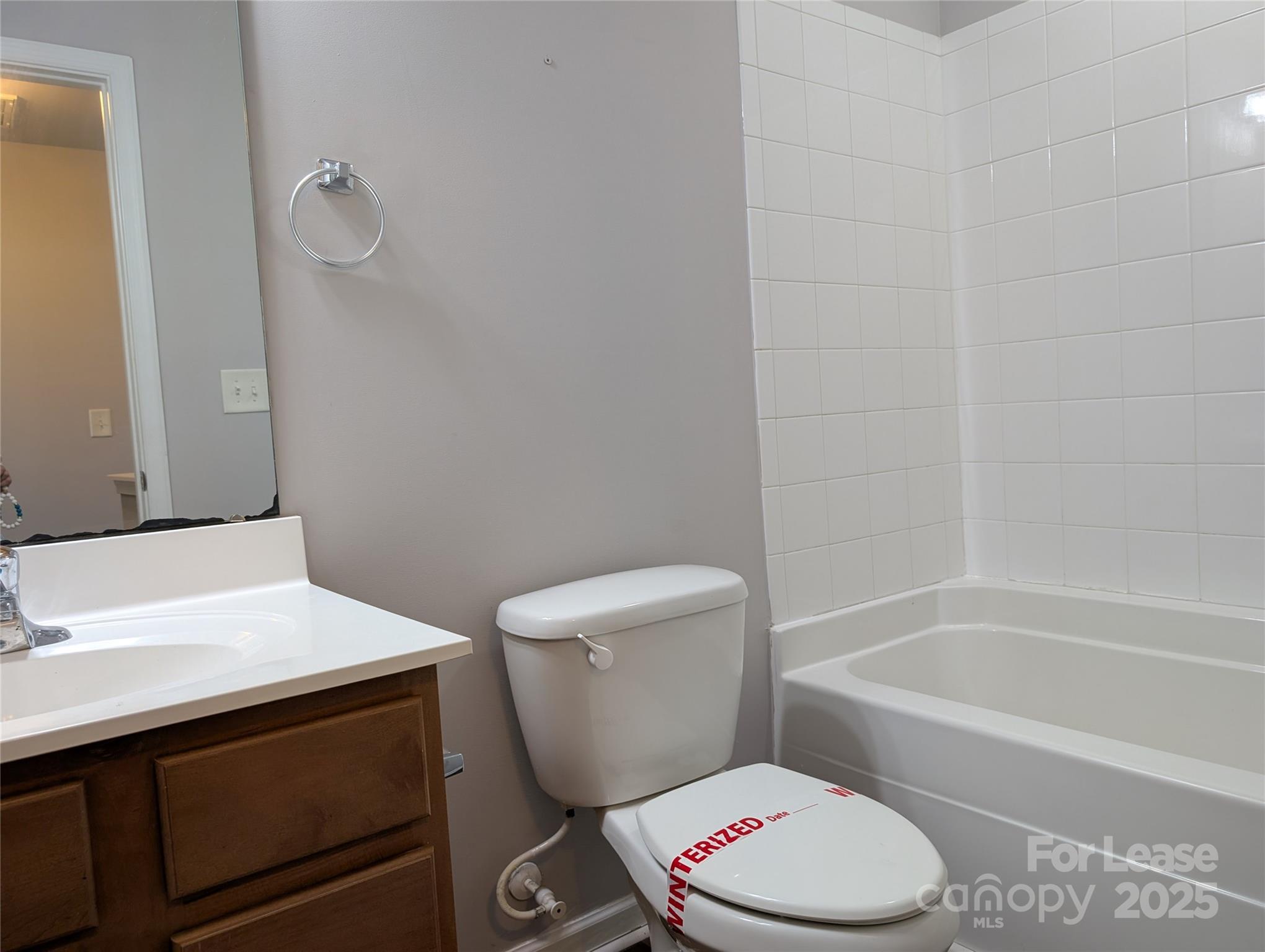 4432 Roundwood Court Indian Trail, NC 28079 - Photo 21 of 25 a white toilet sitting next to a bathroom sink and vanity