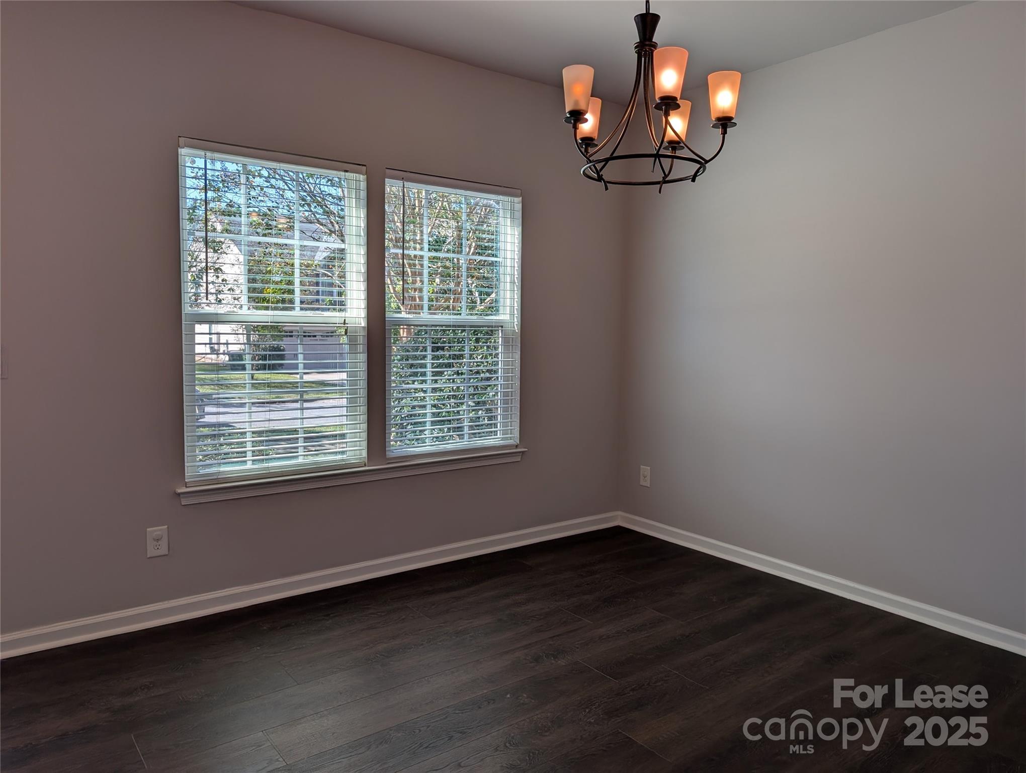 4432 Roundwood Court Indian Trail, NC 28079 - Photo 4 of 25 a view of wooden floor and a chandelier fan in a room