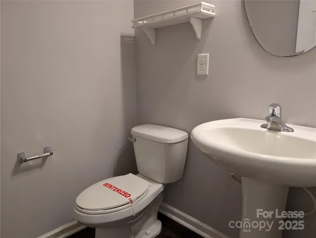 a white toilet sitting next to a bathroom sink
