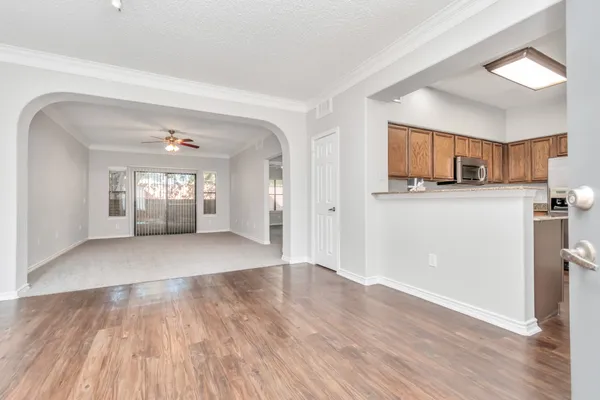 a view of a kitchen with wooden floor and a window