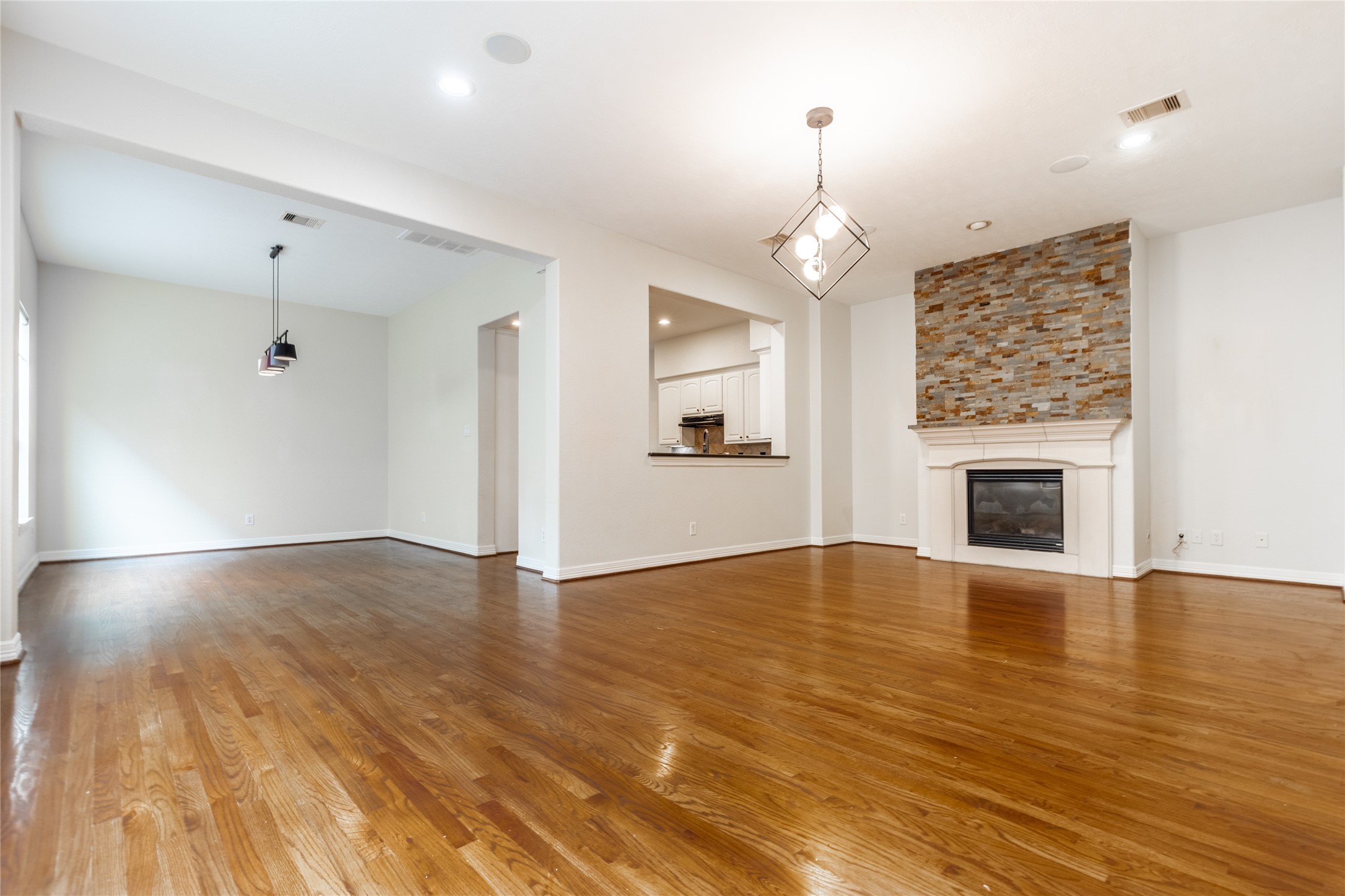 2923 Royal Oaks Crest Houston, TX 77082 - Photo 5 of 31 an empty room with wooden floor fireplace and windows