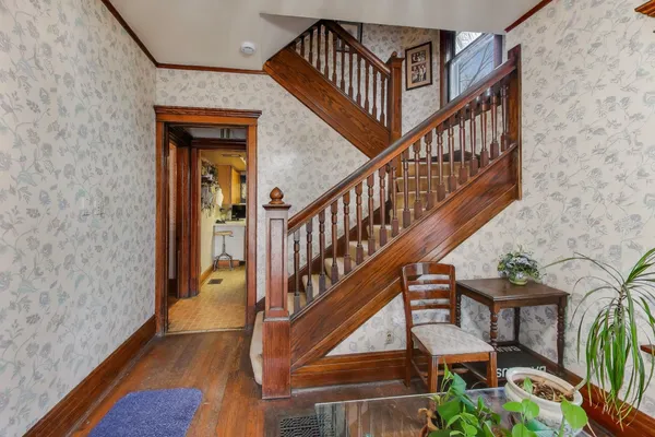 a view of entryway with wooden floor and stairs