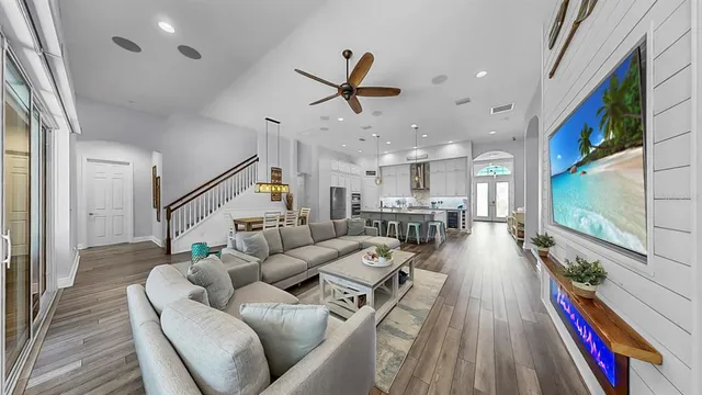 a view of a patio with table and chairs under an umbrella with a barbeque