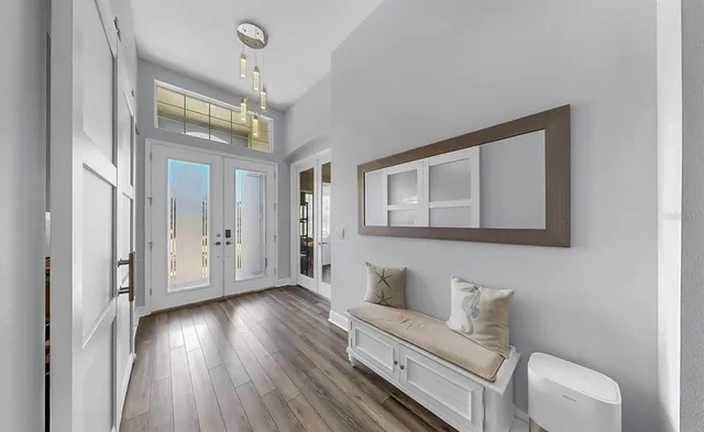 a bedroom with a large bed and a flat tv screen