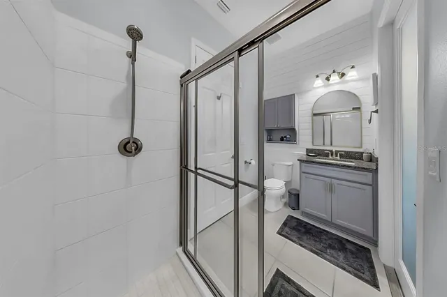 a living room with a bed furniture and a flat screen tv