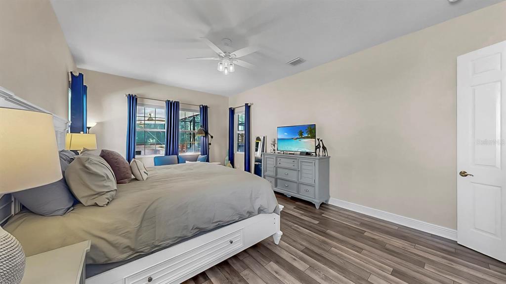 7709 Paradiso Drive Apollo Beach, FL 33572 - Photo 41 of 64 a bedroom with a large bed and a flat tv screen