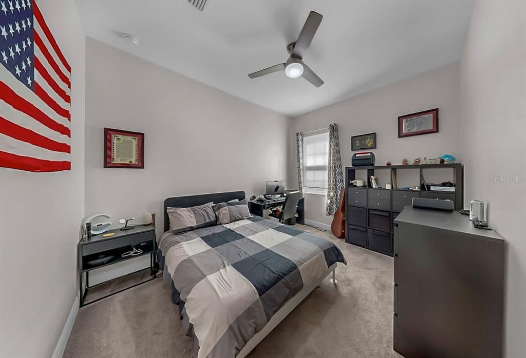 7709 Paradiso Drive Apollo Beach, FL 33572 - Photo 49 of 64 a bedroom with a bed furniture and decor