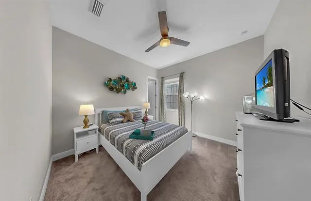 a front view of a house with a yard and potted plants