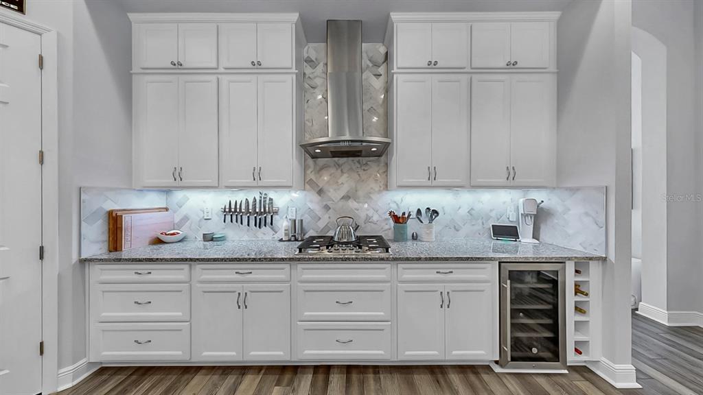 7709 Paradiso Drive Apollo Beach, FL 33572 - Photo 7 of 64 a kitchen with white cabinets and white appliances