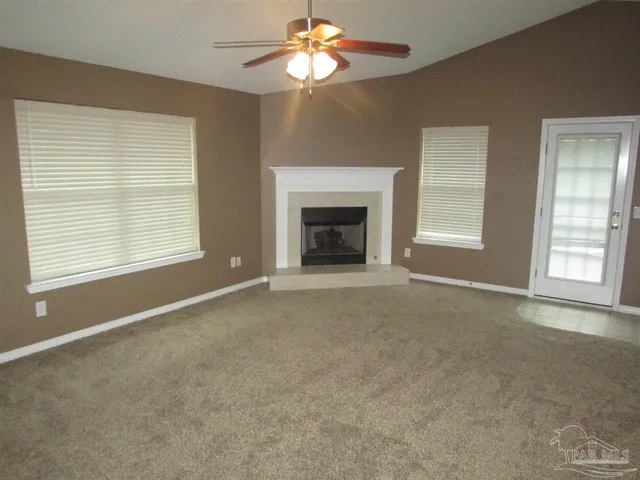 a view of empty room with a fireplace