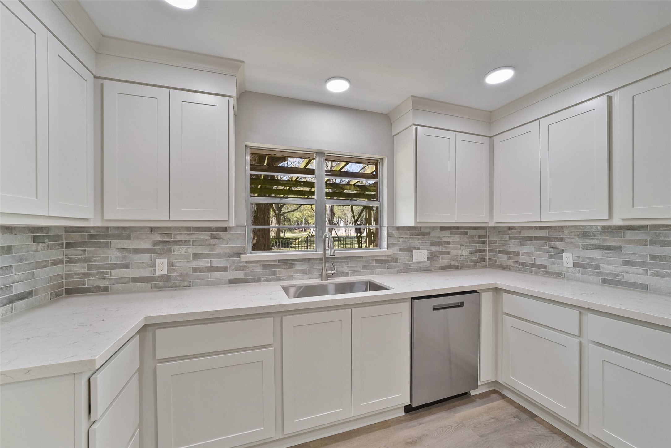 2915 Katy Hockley Road Katy, TX 77493 - Photo 8 of 50 This kitchen is all brand new, waiting for you! Custom Kent Moore cabinets, quartz countertops, beautiful tile backsplash, large farm sink & faucet. New dishwasher. New LED lighting. Luxury vinyl flooring.
