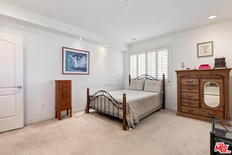 a living room with furniture and a baby crib