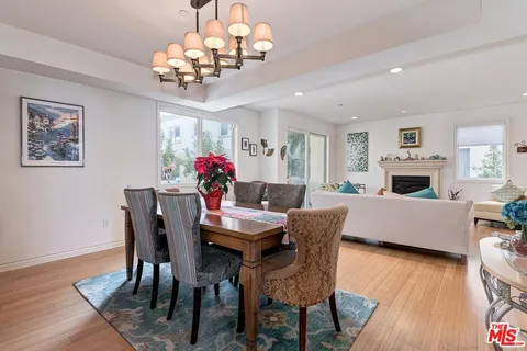 a view of a dining room with furniture wooden floor and chandelier