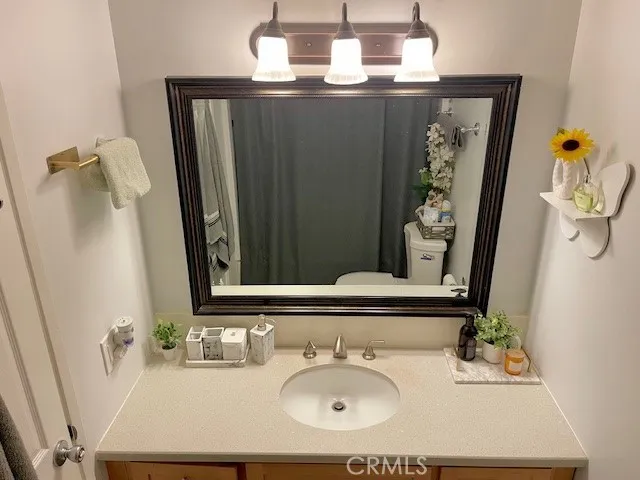 a bathroom with a sink a mirror and vanity