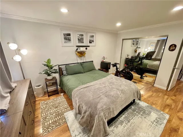 a bedroom with a bed a mirror and desk