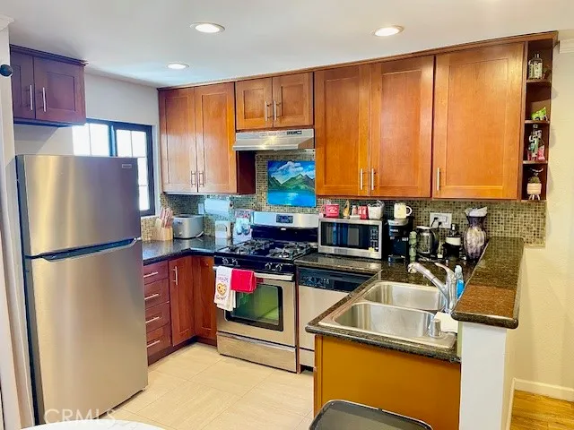 a kitchen with a refrigerator and a sink