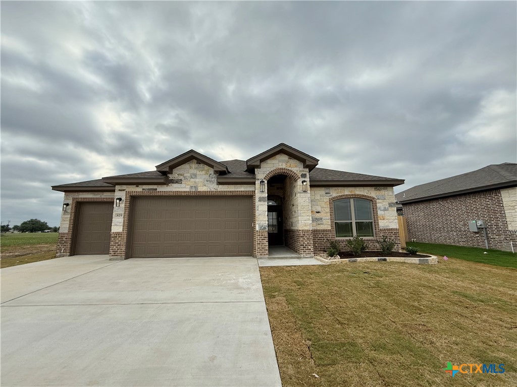 a front view of house with yard and car parked