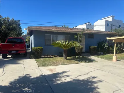 a view of a car park in front of a house