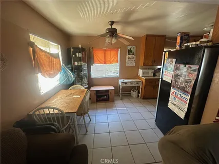 a living room with furniture a window and a flat screen tv