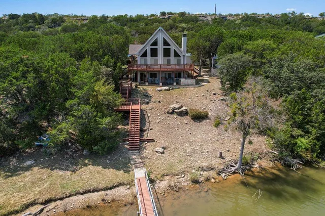 an aerial view of a house with a yard