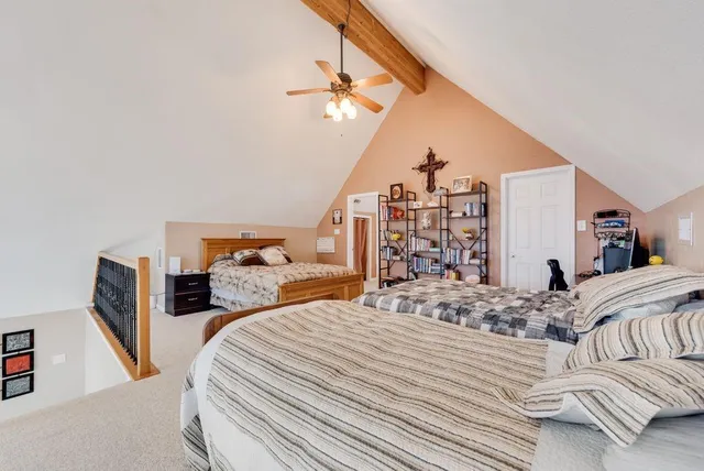 a bedroom with two beds and a chandelier