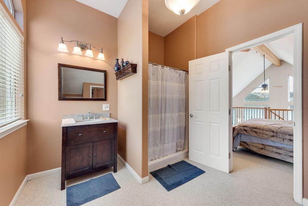 3617 Brandy Road Caddo, TX 76429 - Photo 16 of 40 Full bath featuring vanity, a stall shower, ensuite bath, a ceiling fan, and beam ceiling