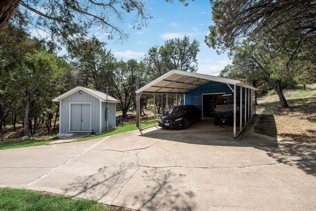 3617 Brandy Road Caddo, TX 76429 - Photo 28 of 40 View of car parking with a shed, a carport, and driveway