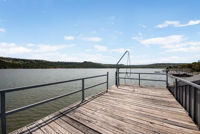 a view of a lake with large trees