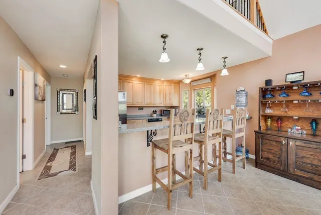 a large kitchen with stainless steel appliances kitchen island granite countertop a sink and cabinets