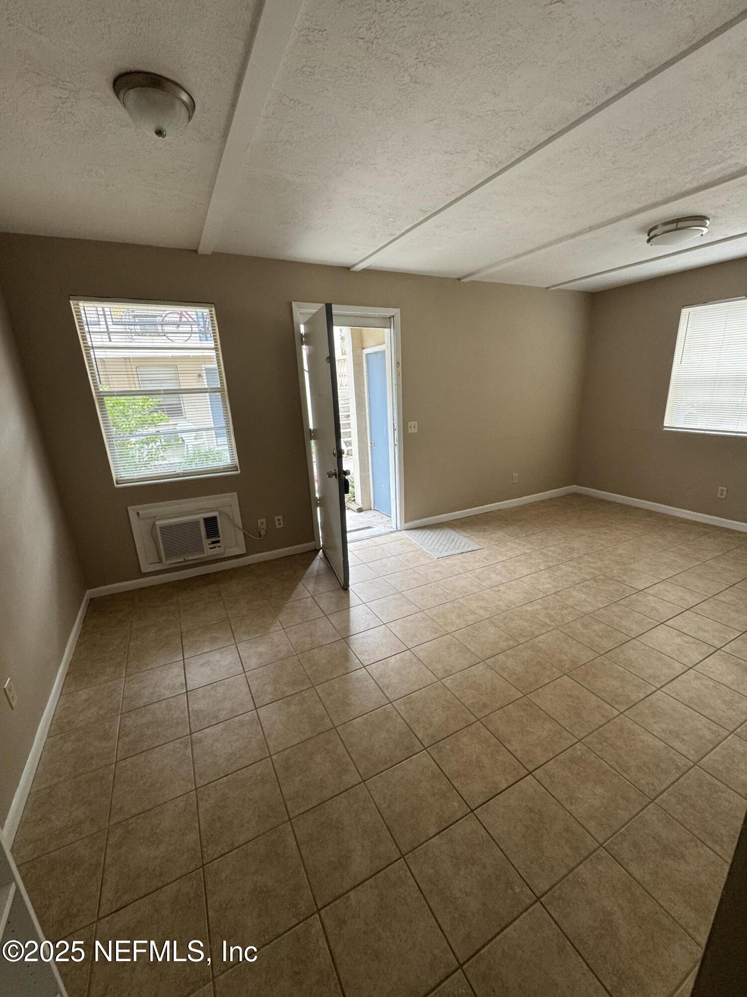 916 Childrens Way, Unit 4 Jacksonville, FL 32207 - Photo 3 of 9 an empty room with windows