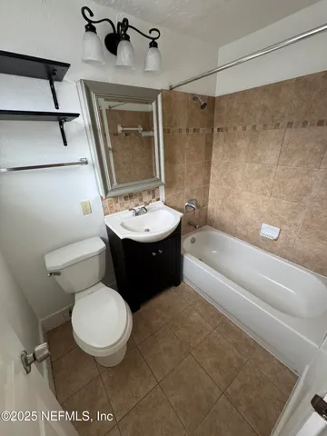a bathroom with a toilet sink and shower