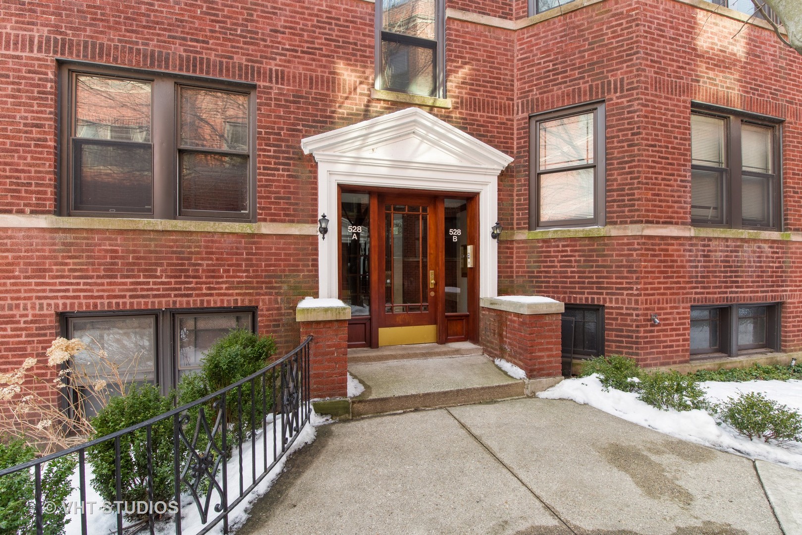 528 Sheridan Road, Unit 3A Evanston, IL 60202 - Photo 1 of 11 a view of a brick house with plants and large tree