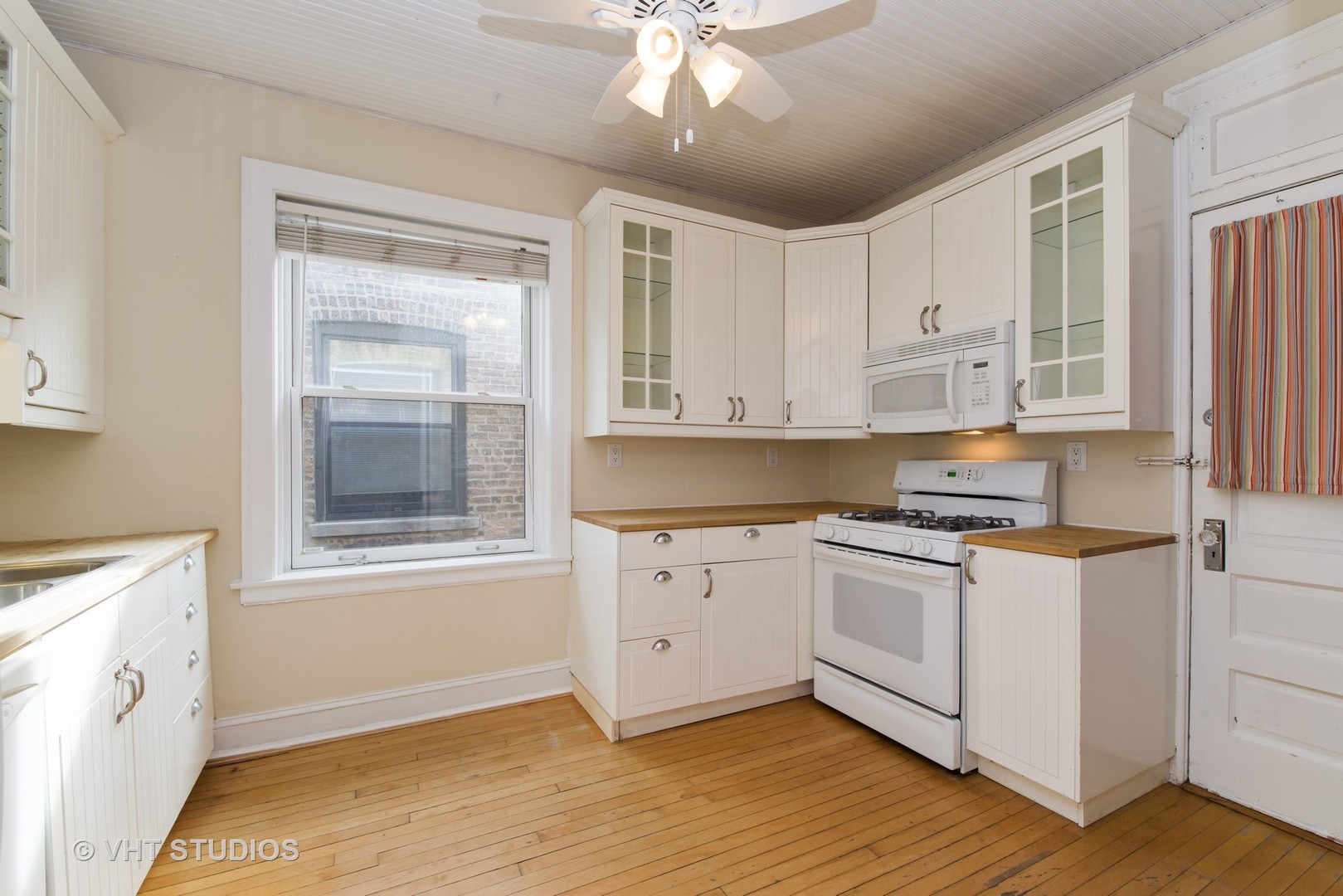 528 Sheridan Road, Unit 3A Evanston, IL 60202 - Photo 6 of 11 a kitchen with stainless steel appliances granite countertop a stove a sink and white cabinets