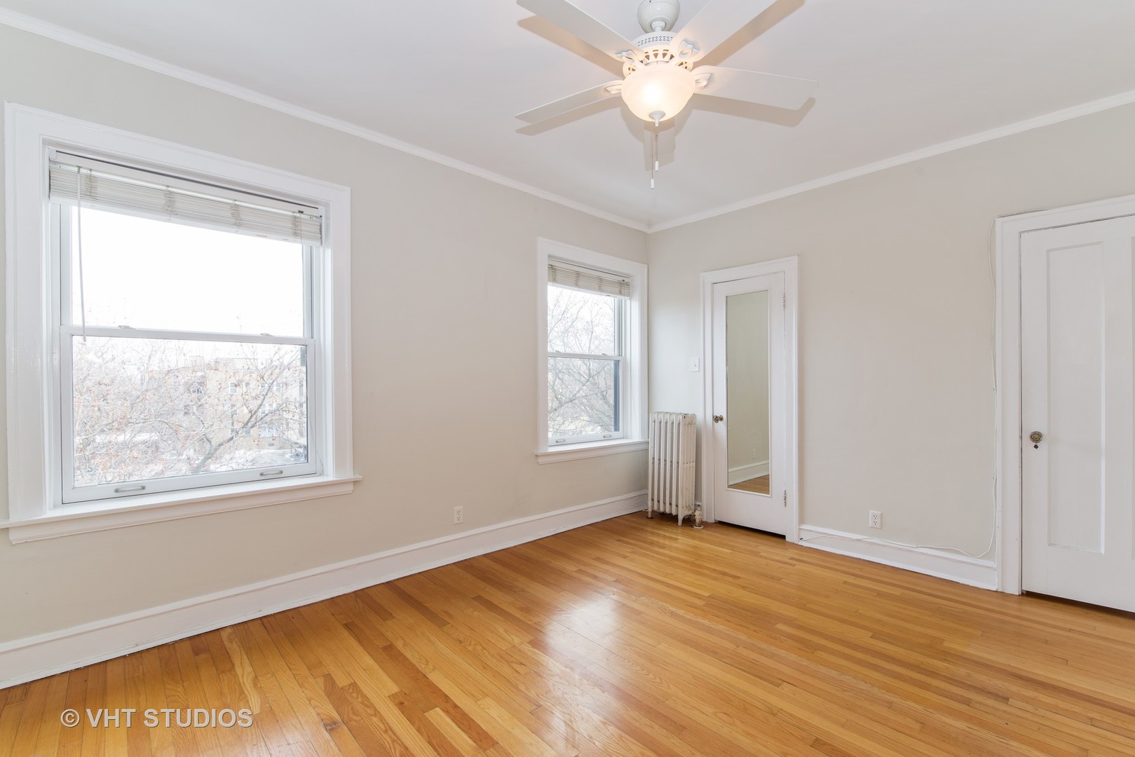 528 Sheridan Road, Unit 3A Evanston, IL 60202 - Photo 8 of 11 a view of empty room with wooden floor and fan