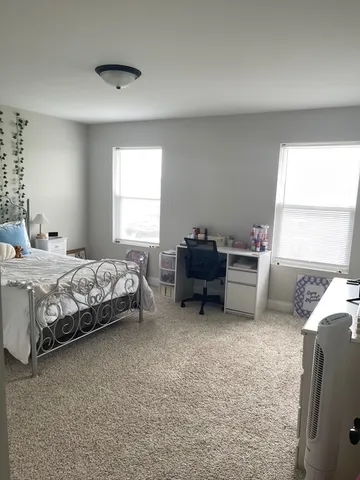 a bedroom with bed and a window