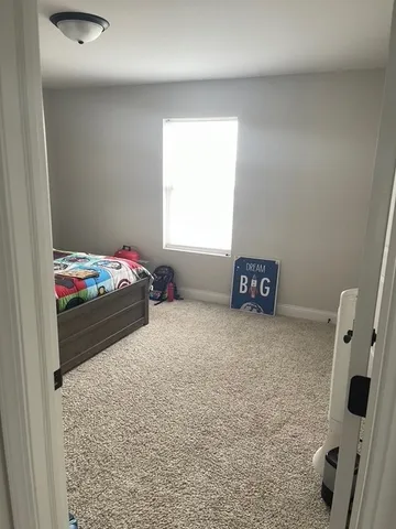 a bedroom with a bed and a television