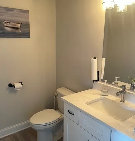 a large spacious bathroom with a granite countertop sink and a window