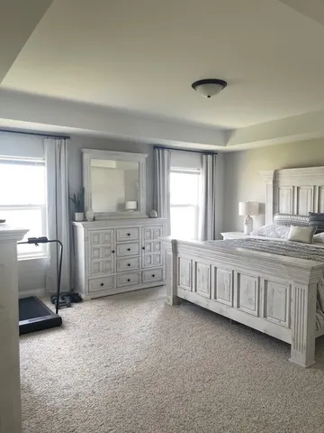 a bedroom with a white bed and a cabinets