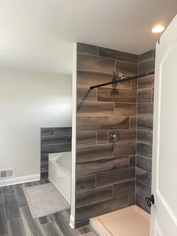 a view of walk in closet with clothes