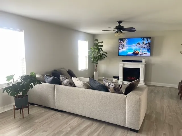 a living room with furniture a chandelier and a fireplace