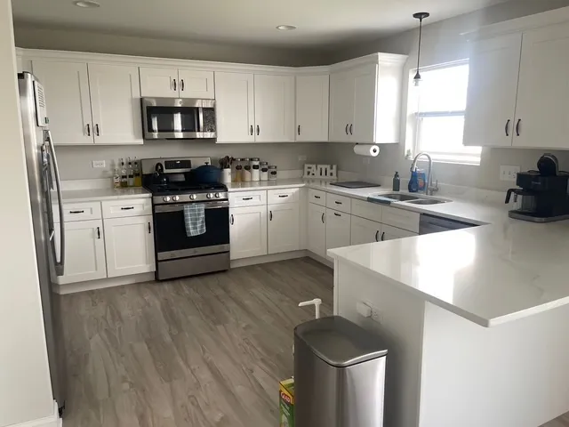 a kitchen with a sink a stove and cabinets