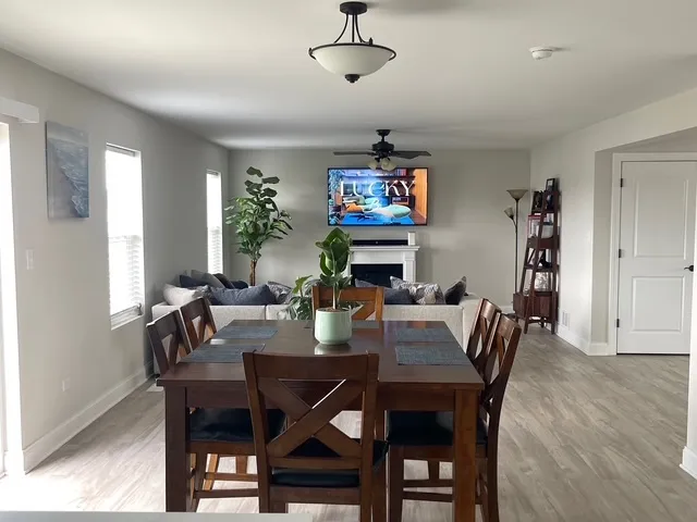 a view of a dining room with furniture wooden floor and a chandelier